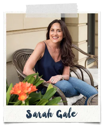 Taped polaroid of Sarah Gale in a cane chair with orange flowers, captioned Sarah Gale